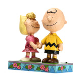 Sally holding Charlie Brown hand
